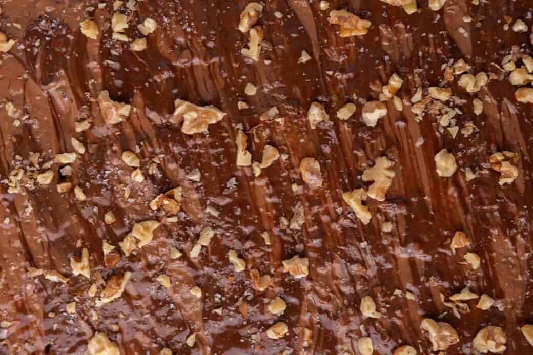 Close-up of melted chocolate spread over banana bread Christmas crack with walnuts and sea salt.