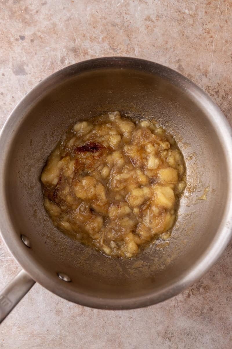 Mashed bananas caramelizing in brown butter in a saucepan