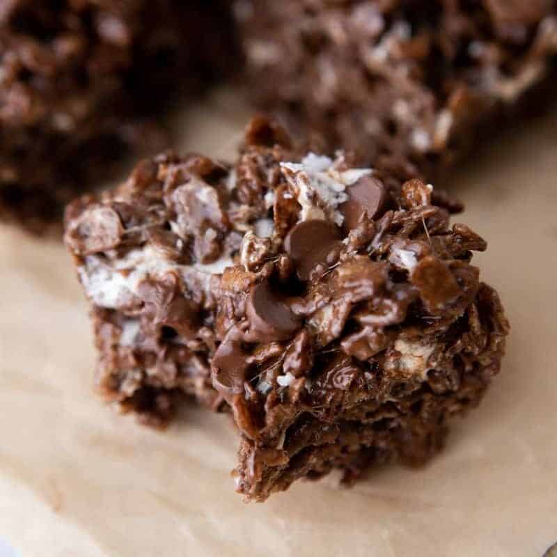 Single chocolate rice krispie treat square topped with melted chocolate chips, marshmallow, and flaky sea salt
