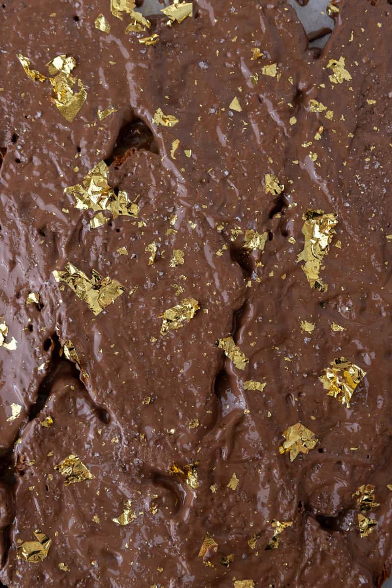 Croissant Christmas crack topped with melted chocolate, flaky salt, and edible gold leaf