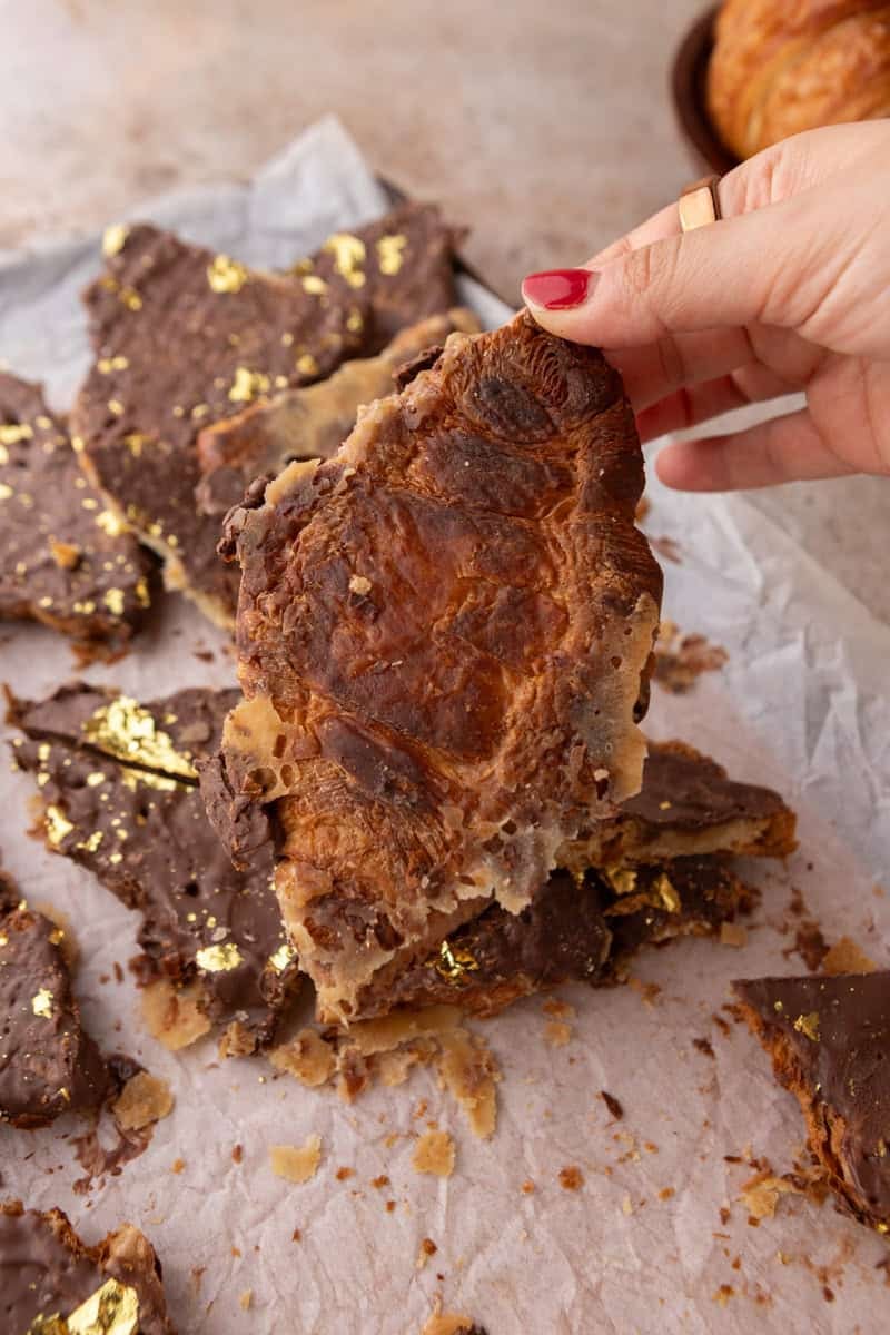 Underside of a croissant Christmas crack piece showing toffee soaked into the flaky croissant layers