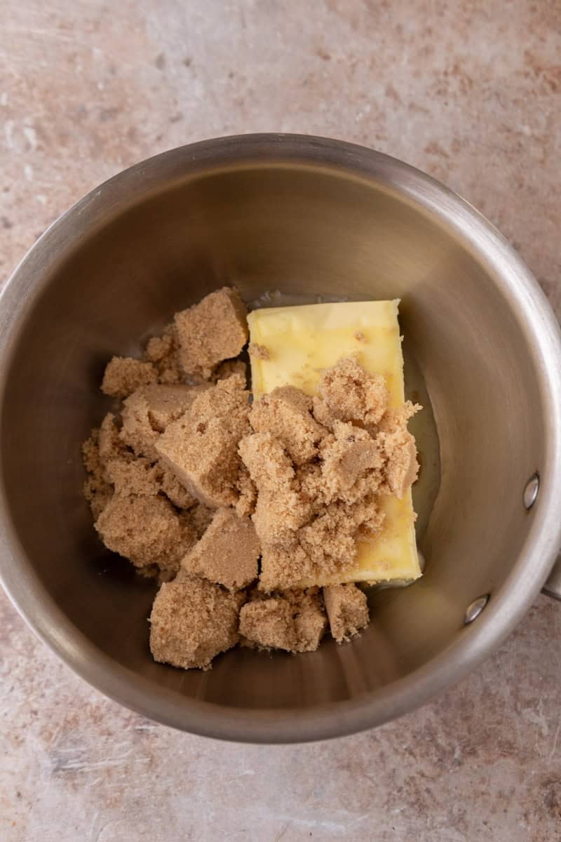 Unsalted butter and light brown sugar in a saucepan before making toffee for croissant crack