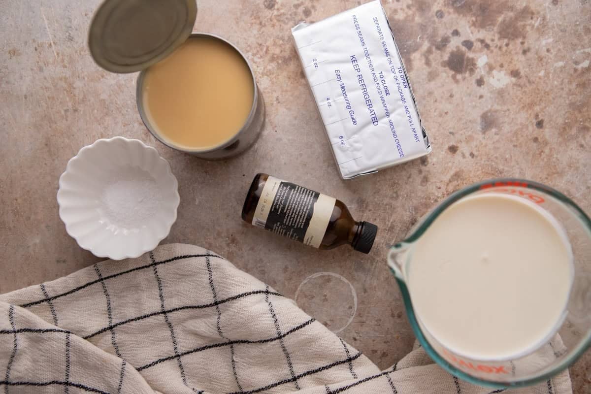 cream cheese, sweetened condensed milk, and vanilla being mixed in a bowl for no-churn cream cheese ice cream