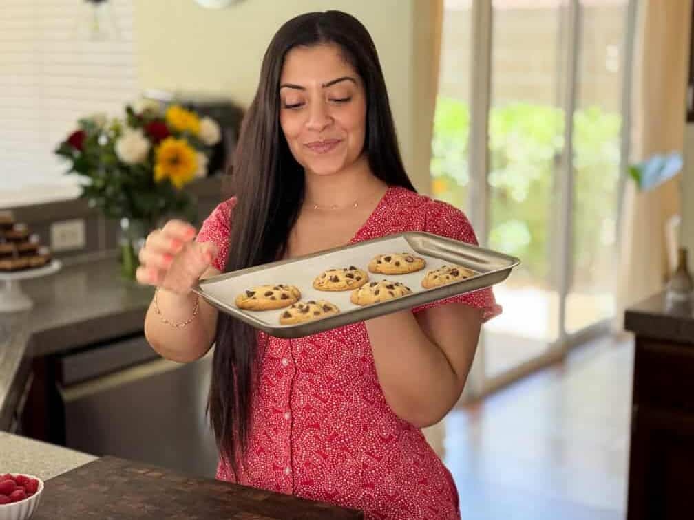 Chahinez from Lifestyle of a Foodie holding a tray of chocolate chip cookies for Loaf BakeClub