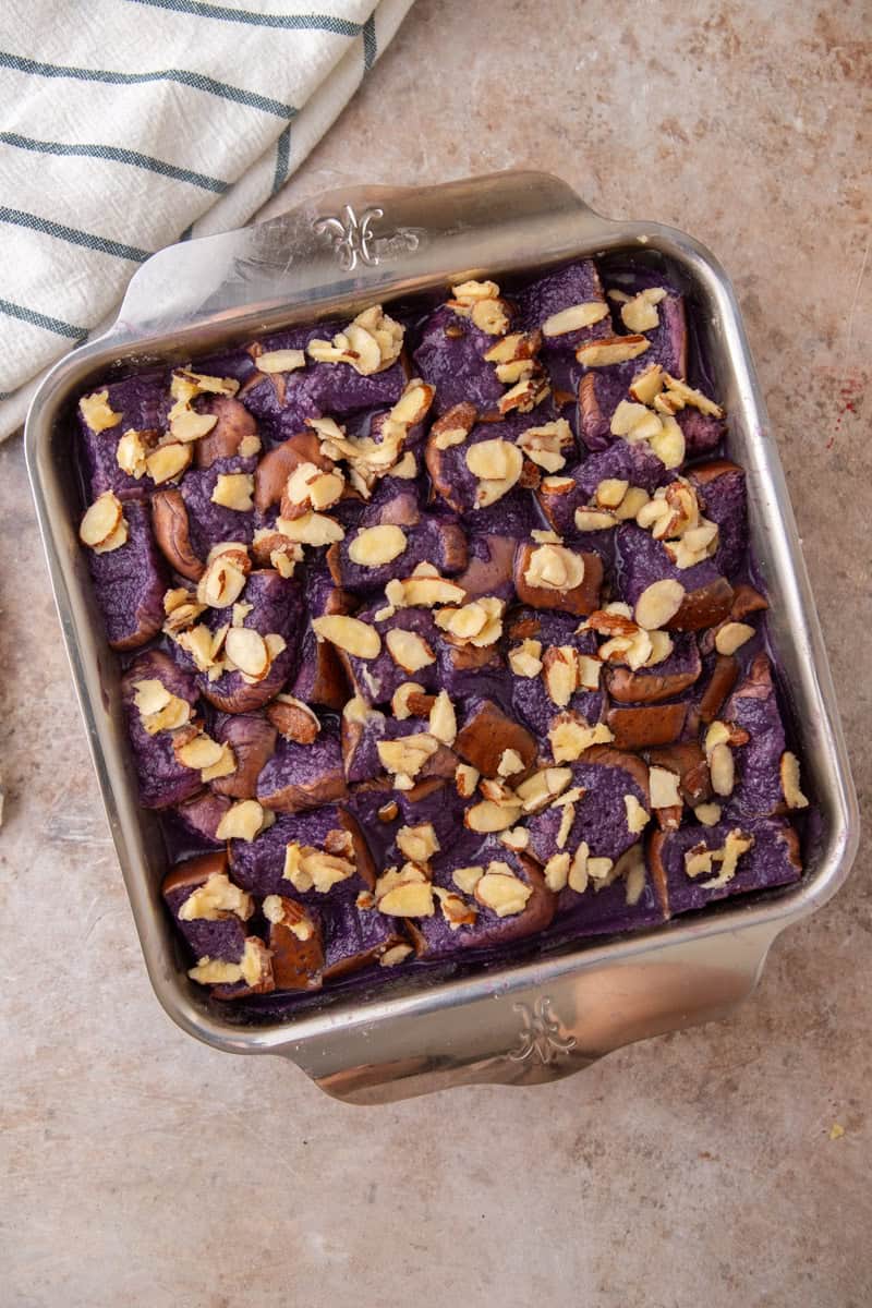 Soaked French toast bake topped with buttered sliced almonds and ready to go in the oven