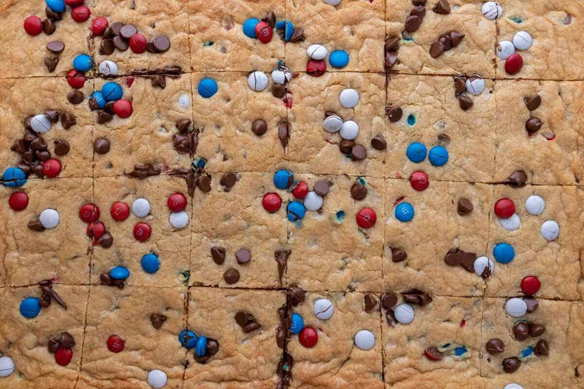 Sliced red white and blue cookie bars showing the soft chewy center