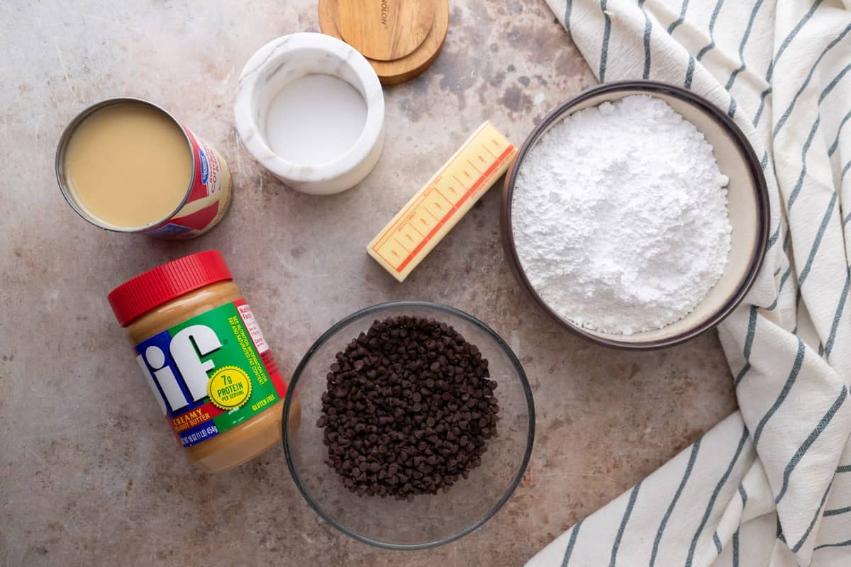 Buckeye fudge ingredients including peanut butter, condensed milk, powdered sugar, and chocolate chips