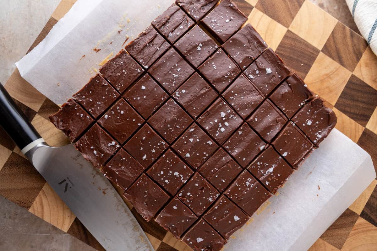  Buckeye fudge cut into squares on a cutting board topped with flaky salt