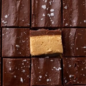 Overhead of buckeye fudge squares with one turned to show the peanut butter and chocolate layers