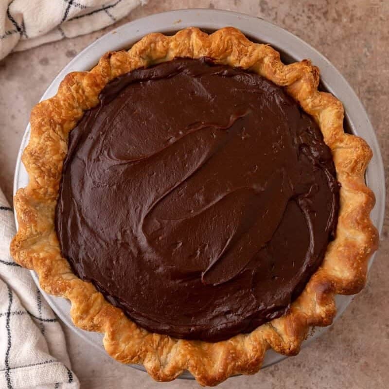 chocolate custard filling poured into pie crust before refrigerating