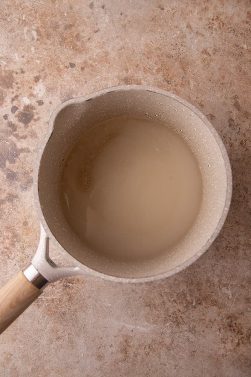 Sugar, water, and corn syrup simmered into a clear syrup in a small saucepan.