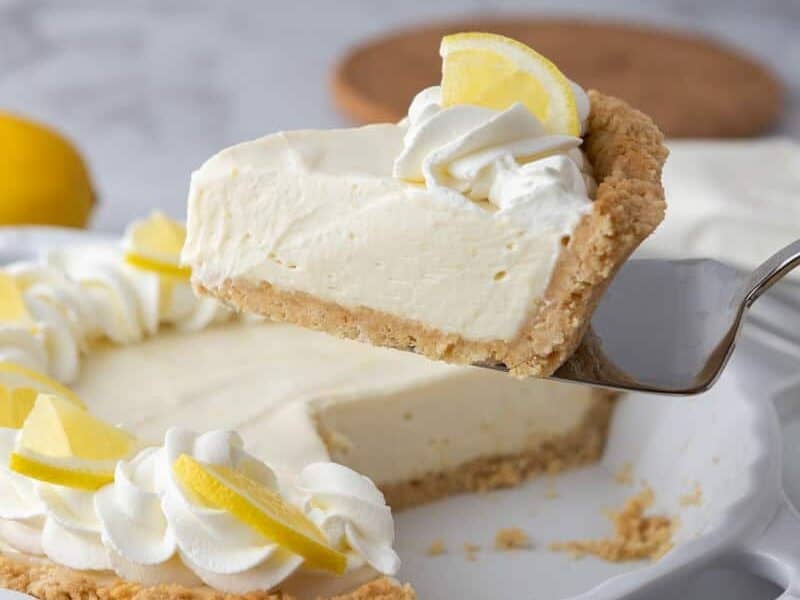 slice of the no bake lemon pie being held up