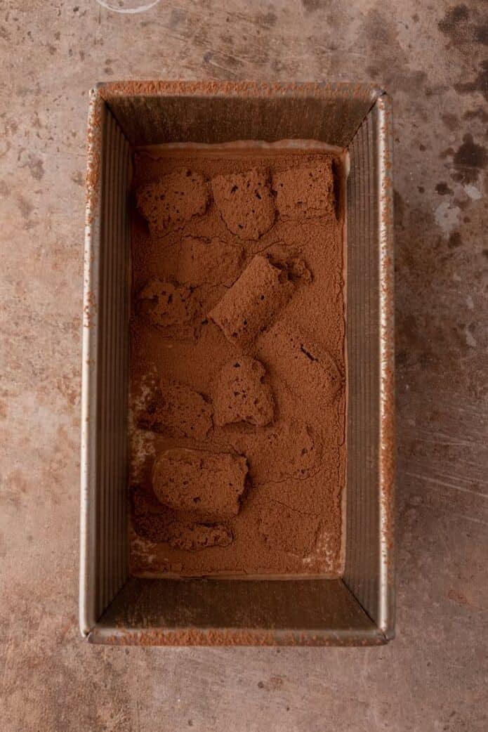 first layer in the pan covered with cocoa powder
