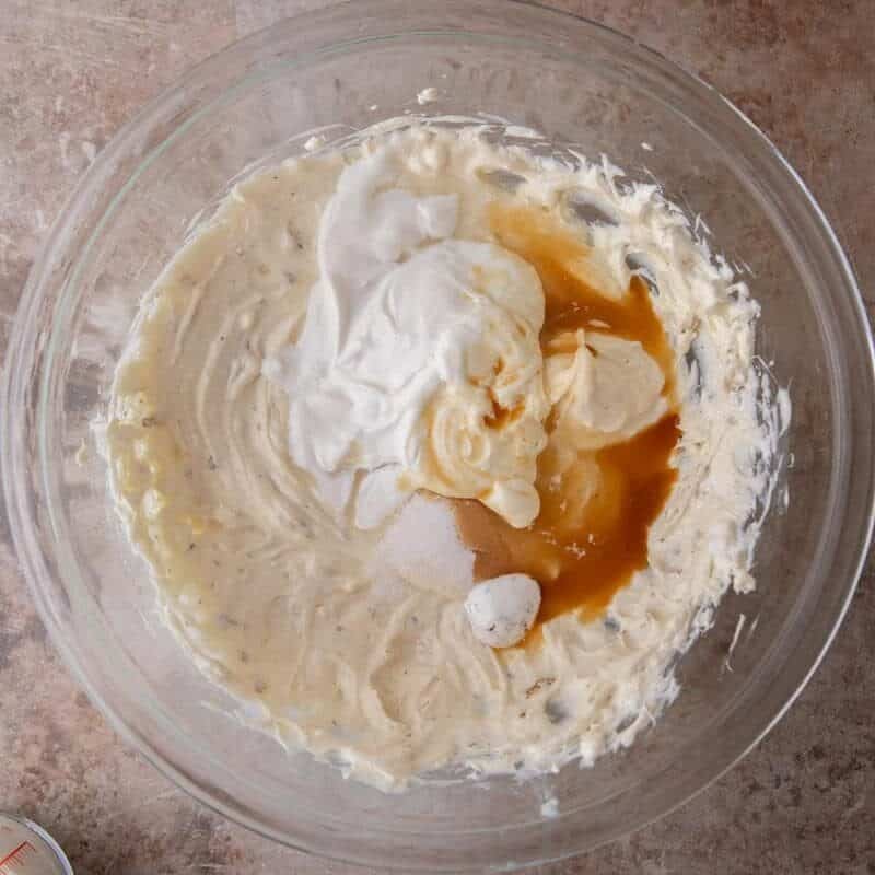 Sour cream, sugar, and vanilla extract added to the marshmallow cream cheese mixture for s'mores cheesecake bars