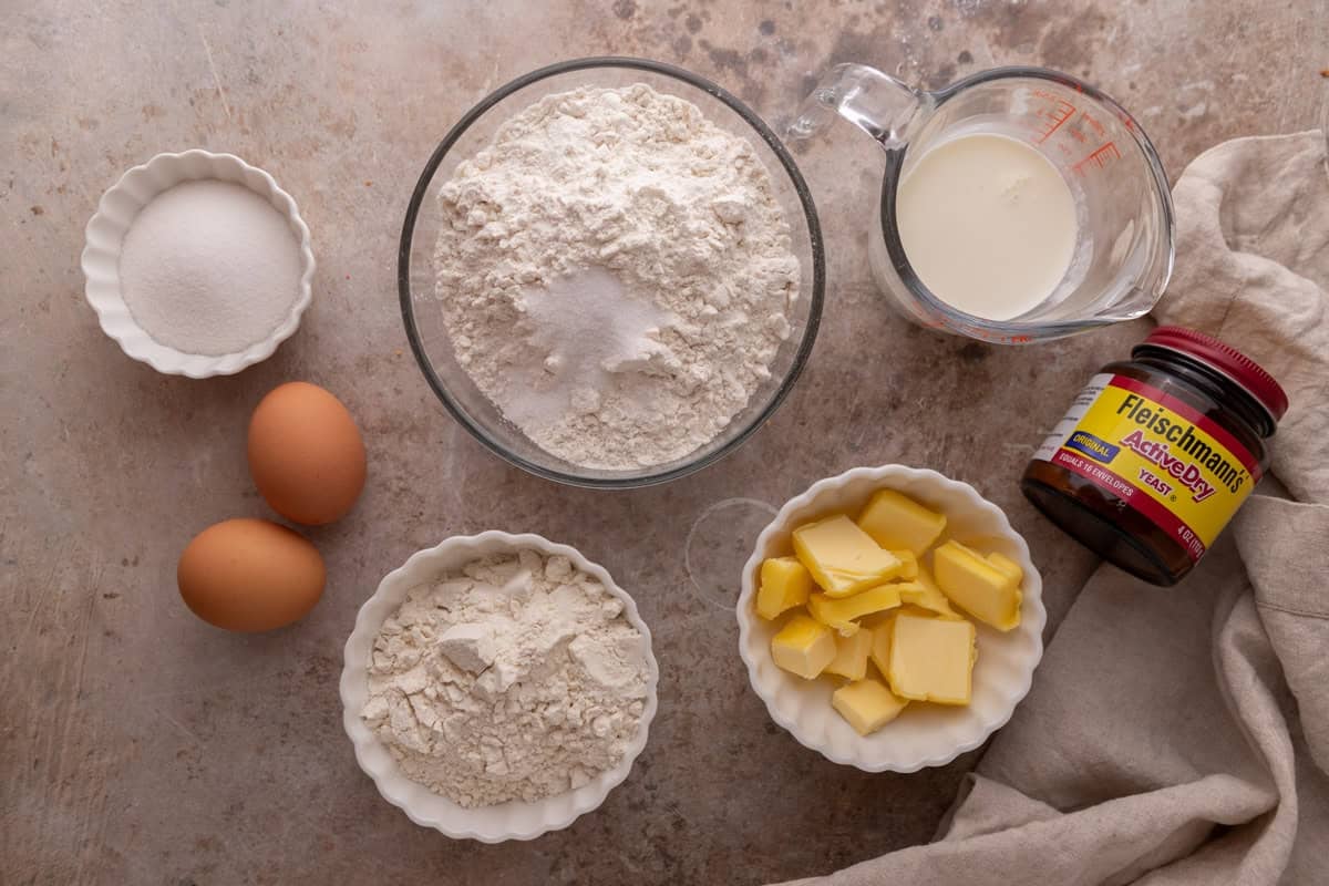 Brioche dough ingredients including flour, milk, eggs, butter, sugar, and active dry yeast