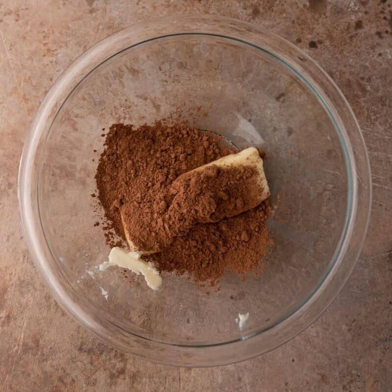 the first group of ingredients in the bowl for the brownie frosting recipe