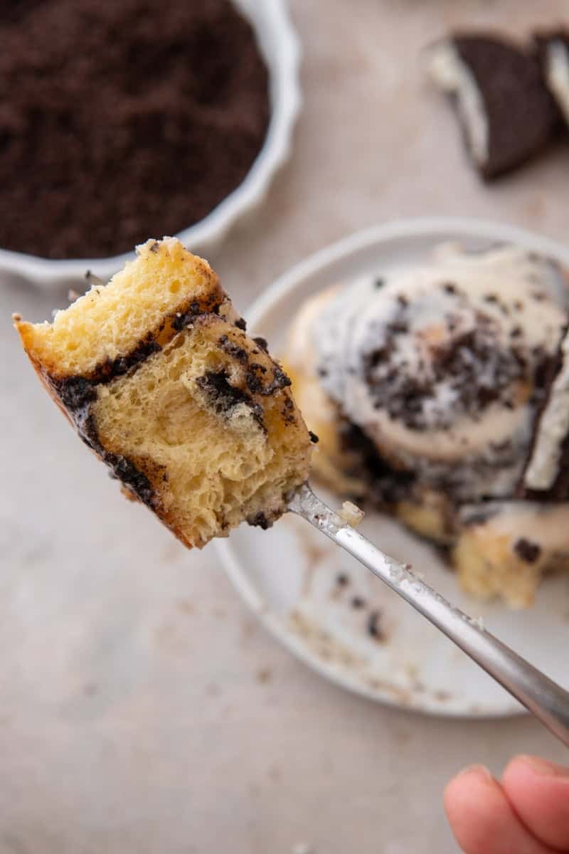 Forkful of Oreo cinnamon roll showing the soft interior and Oreo filling swirl