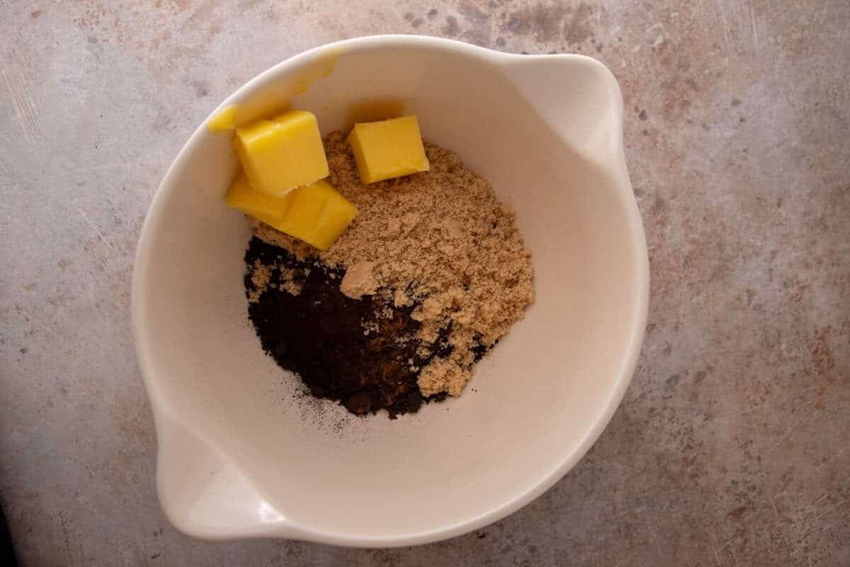Butter, brown sugar, and black cocoa mixed together for Oreo cinnamon roll filling