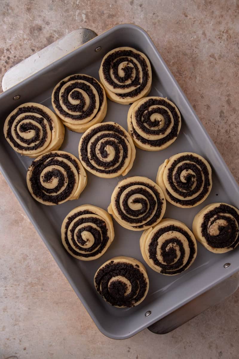 Unbaked rolls arranged in a baking pan before their second rise