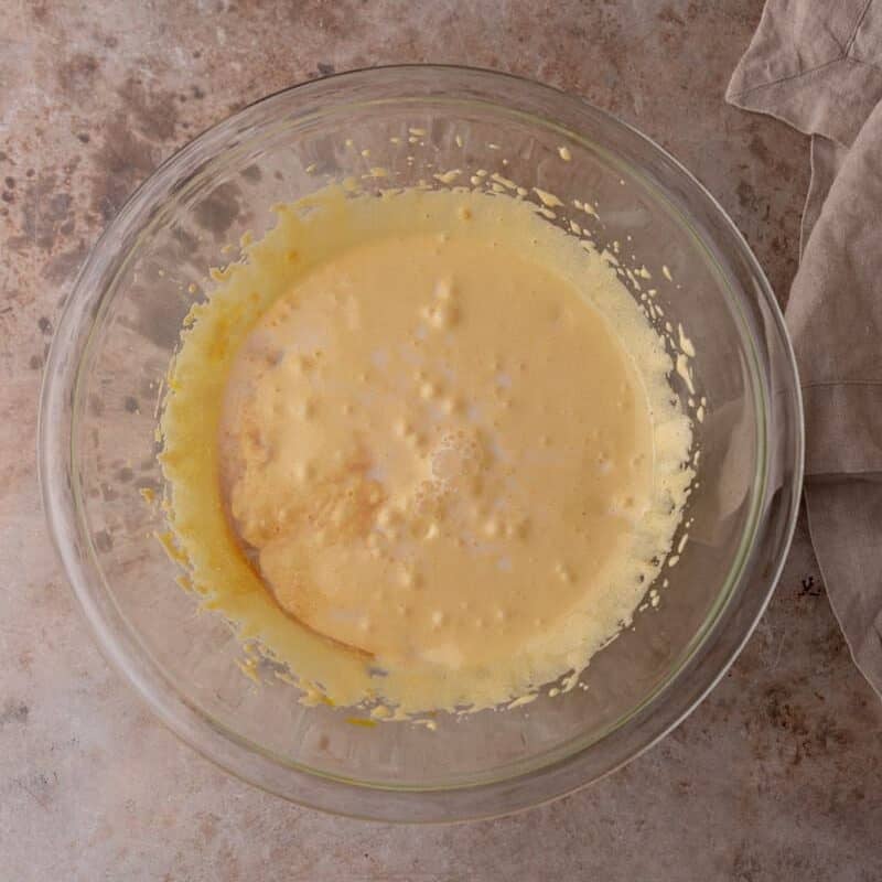 Beaten egg yolks and sugar mixed into a pale, foamy batter