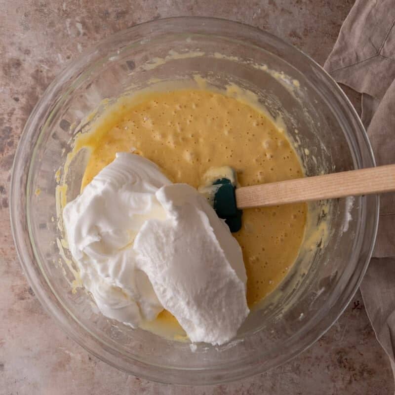 Whipped egg whites being folded into cake batter