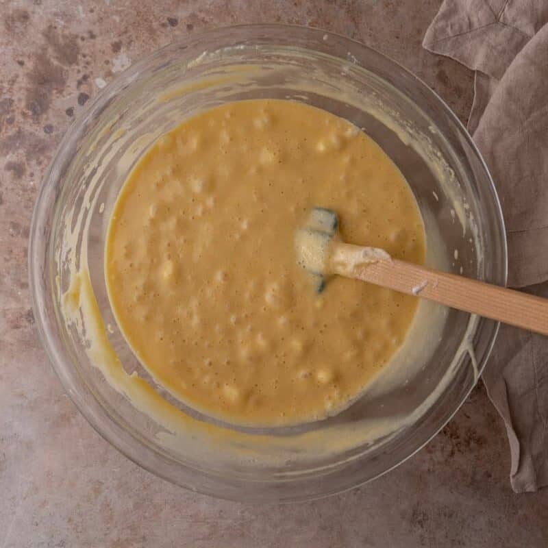 Tres leches cake batter fully mixed and aerated in a glass bowl