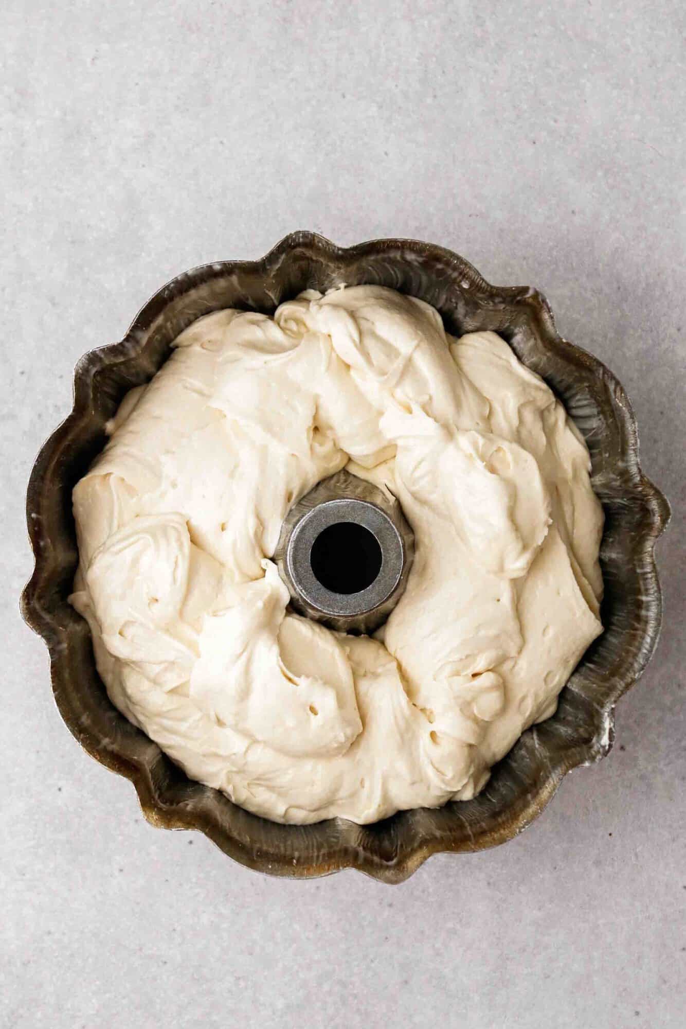 Vanilla bundt cake batter poured into the pan