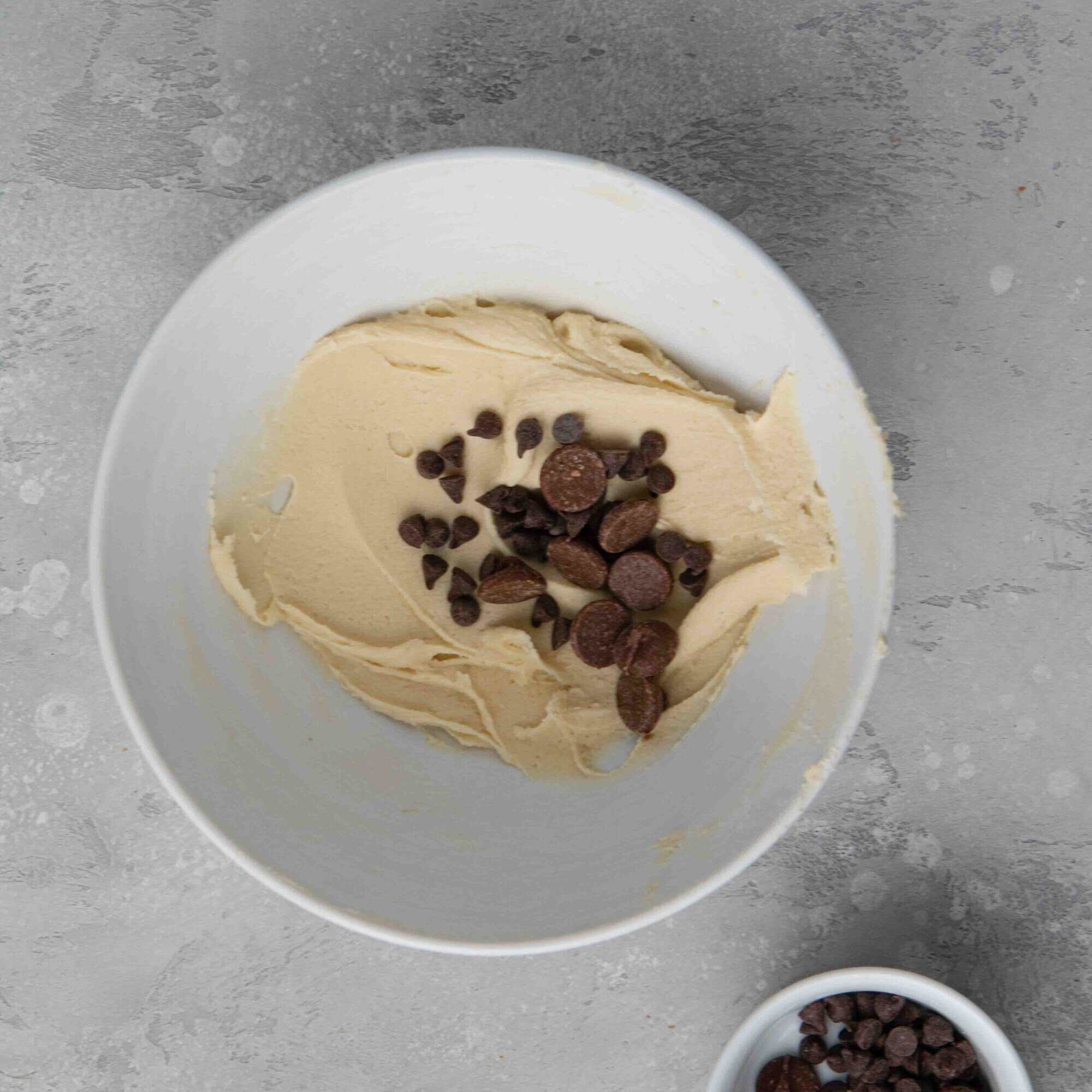 Adding semi sweet chocolate chips to the cookie dough mixture
