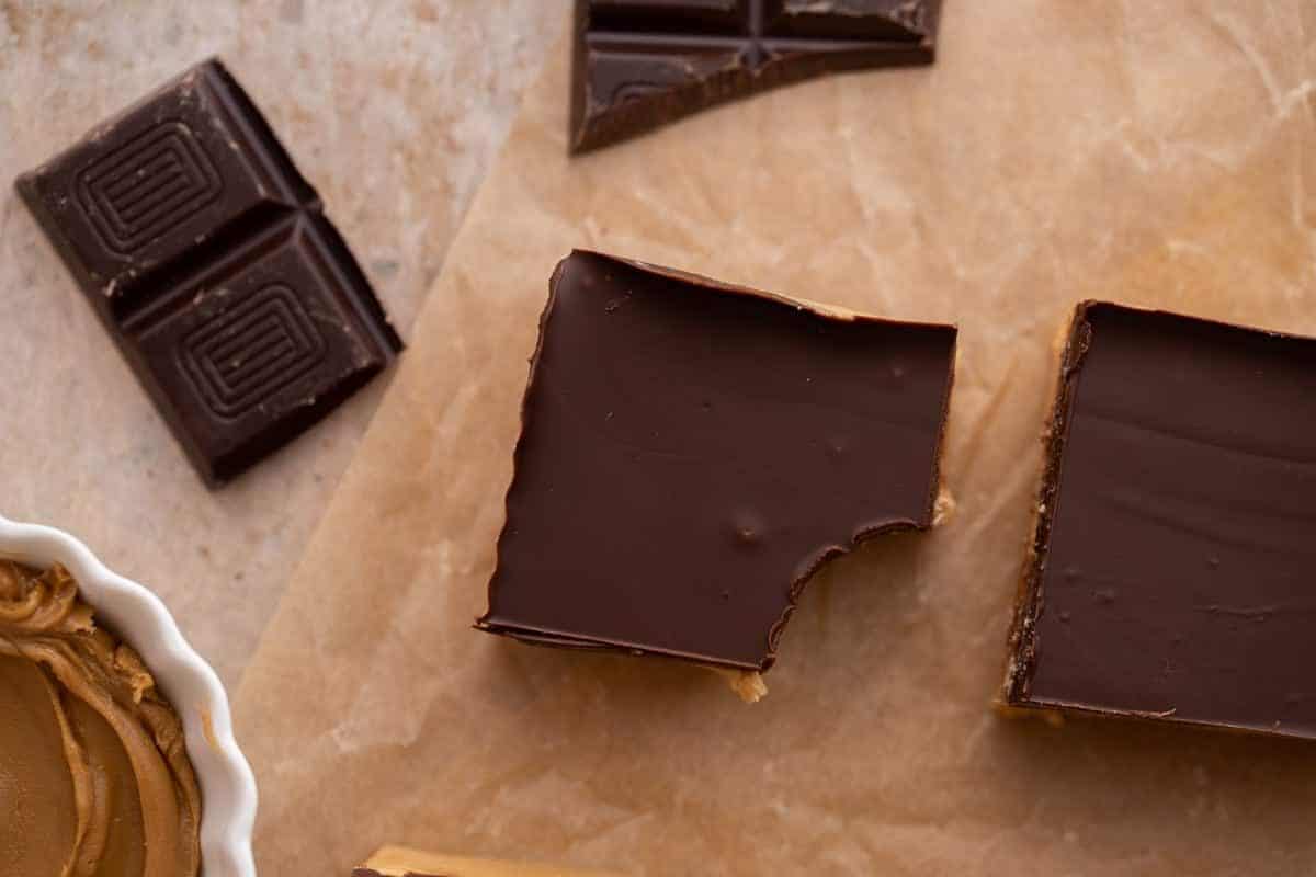 close up of a single square of chocolate with a bite taken out of it