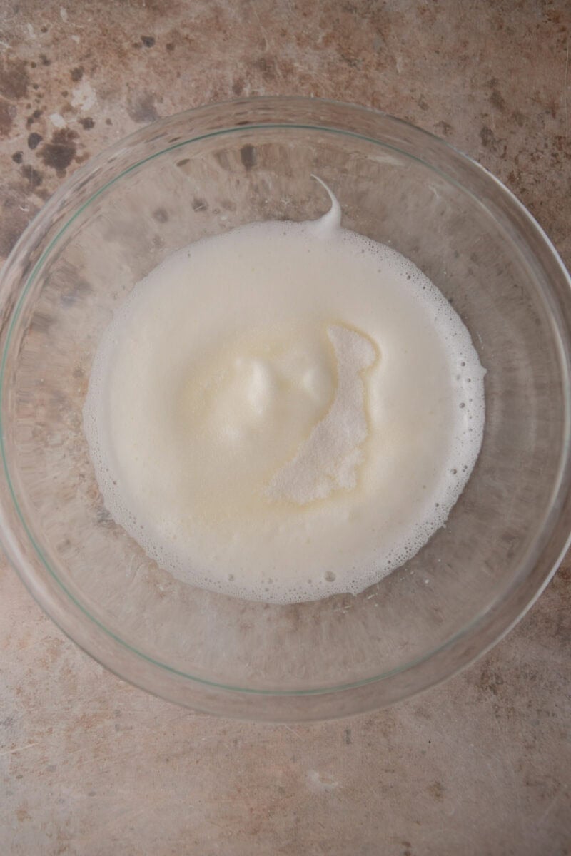Glossy whipped meringue in a bowl after the sugar is slowly added.