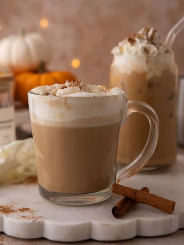 Copycat Starbucks pumpkin spice latte in a glass mug with whipped cream and spice dusting.