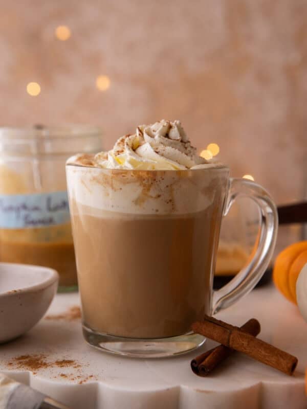 Finished pumpkin spice latte topped with whipped cream, pumpkin pie spice.
